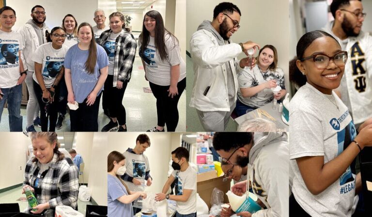A collage of six photos showing a diverse group of people engaged in a community service activity indoors. In the top left image, eight people stand together smiling, some wearing matching t-shirts with a graphic and text. The top middle image shows a man pouring a liquid into a cup held by a seated woman. The top right image features a smiling woman wearing glasses and a matching t-shirt, with a man in the background. The bottom left image captures a woman in a plaid shirt holding a bottle. The bottom middle image shows three people, two wearing masks, working together with supplies on a table. The bottom right image depicts two people closely working with cups and containers. The setting appears to be a hallway or common area with a tiled floor and fluorescent lighting.