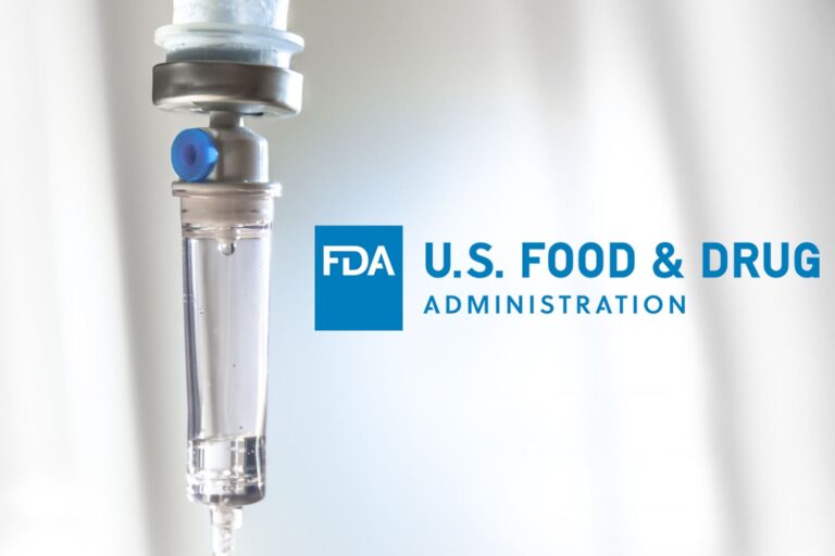 IV drip chamber with a drop of liquid falling inside, next to the U.S. Food & Drug Administration (FDA) logo on a light background.