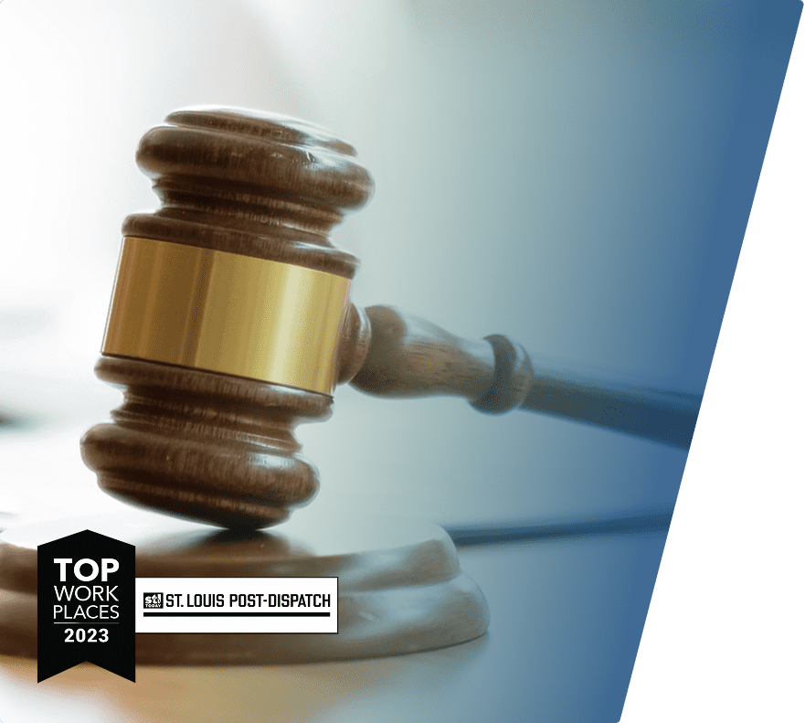 Wooden judge's gavel with a gold band resting on a sound block, overlaid with a "Top Work Places 2023" badge and the St. Louis Post-Dispatch logo.