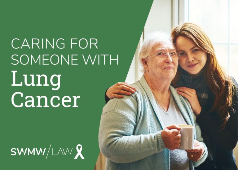 An elderly woman with white hair and glasses, wearing a light blue cardigan, is holding a white mug. A younger woman with long brown hair, wearing a dark sweater and scarf, is standing beside her with her arm around the elderly woman's shoulder. The background includes a window with natural light. The left side of the image has a green background with white text that reads "Caring for someone with Lung Cancer" and the logo "SWMW Law" with a white awareness ribbon.